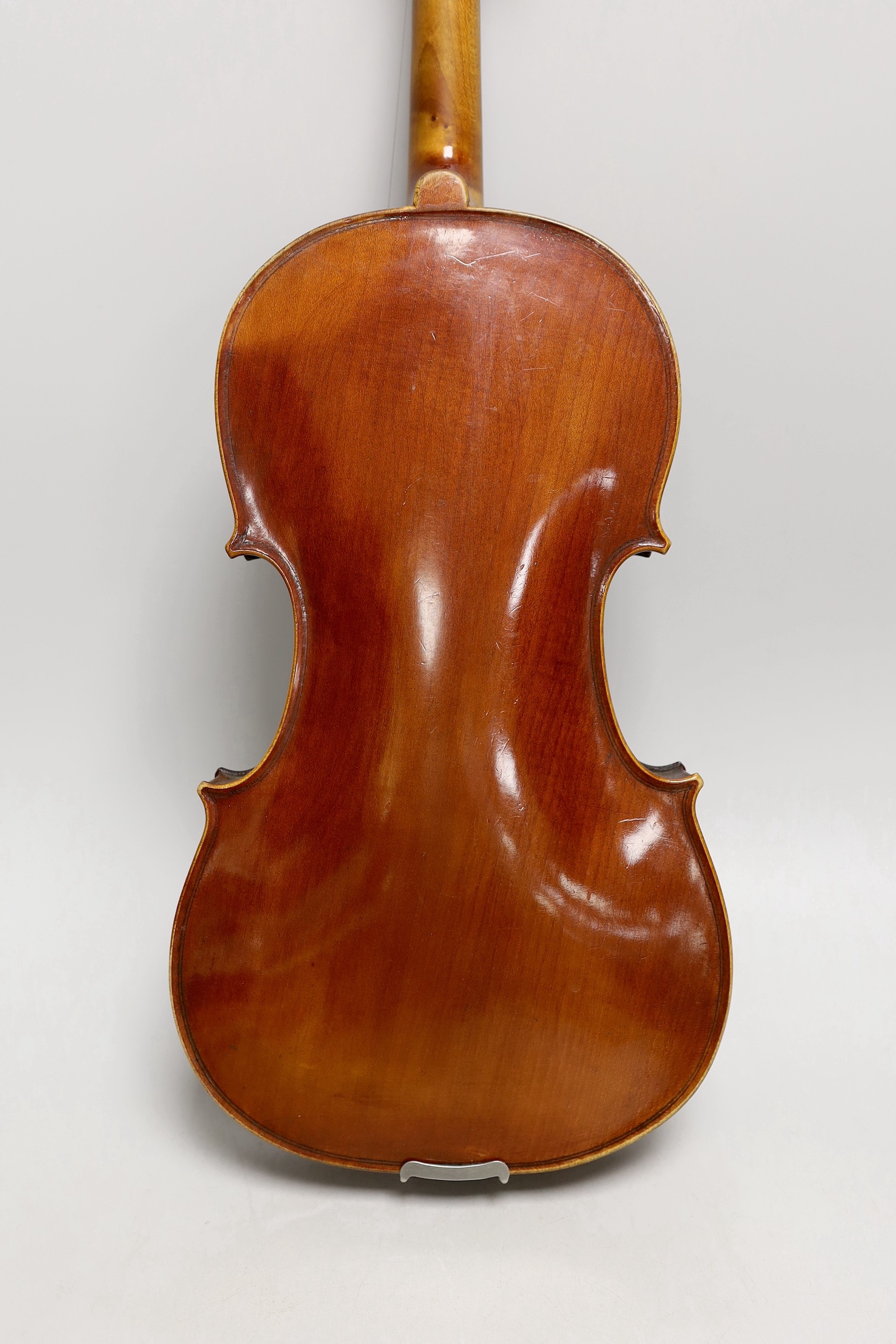 A French single back violin, interior label reads ‘Médio Fino’, back measures 35.5cm excl button. With case and bow